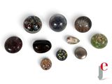 many different types of stones on a white surface