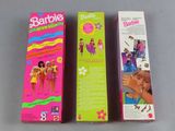 two barbie dolls are sitting next to each other on a table