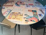 a round table made out of newspapers on the floor