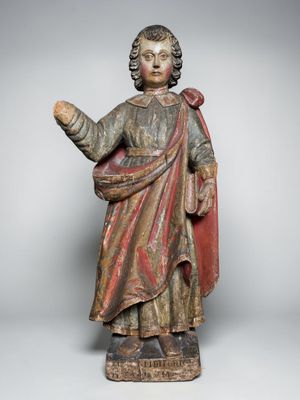 a wooden statue of a man with a red robe and a red cloak