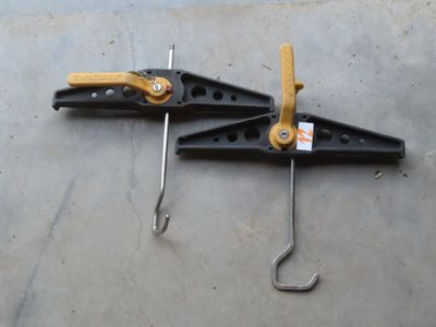 two clamps that are on the floor next to each other