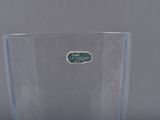 a clear glass with a green label on it