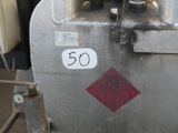 a metal tank with a red and white sign on it