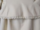 a picture of a white dress with a frilling on the bottom
