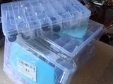 two plastic boxes sitting on top of a table