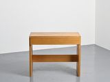 a small wooden table in the corner of a room