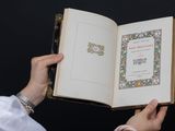 a person holding an open book with a picture on it