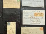 a black folder with a lot of old postcards on it