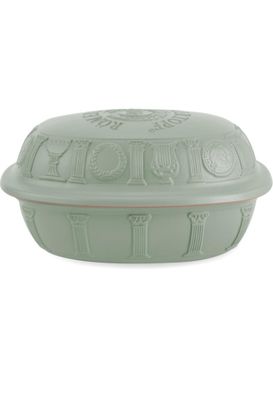 the lid of a green casserole dish is covered with a decorative design
