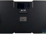 a close up of a bathroom scale with a clock on it