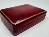 an image of a red box with gold trim on a white surface