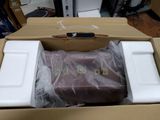 a cardboard box with a piece of luggage inside of it