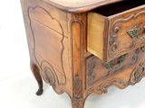 a small wooden chest of drawers with a drawer underneath it