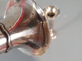 a silver object that is on the handle of a faucet