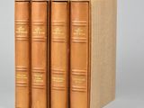 trois livres sont empilés sur une surface grise