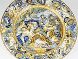 a blue and yellow plate with a painting on it
