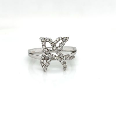 a close up of a diamond ring on a white surface