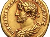 a close up of a gold coin with an image of a man on it