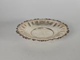a silver plate with a decorative design on the rim