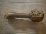a ball of yarn and a wooden stick on the floor