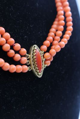 a close up of a necklace on a mannequin mannequin