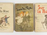 three children ' s books are lined up on a white surface
