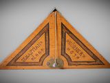 an old wooden triangle with chinese writing on it