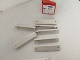 five pieces of white plastic sitting on a white surface