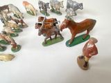 many figurines of different types of animals on a white surface
