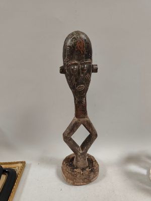 a statue of a man with a hat on a table