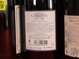 several bottles of wine are lined up on a shelf