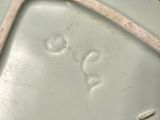 a white bowl with a handle on top of it