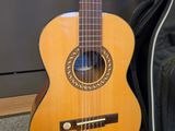 a guitar sitting next to a bag on the floor