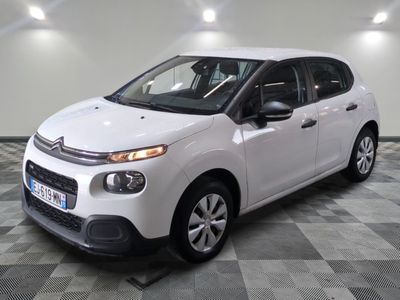 the white citrole is parked in the garage on a checkered floor