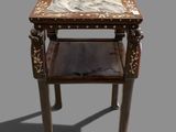 a small table with a marble top on a gray background