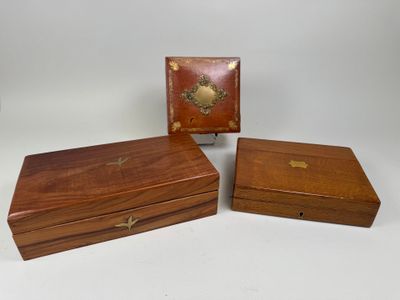 three small wooden boxes with brass decorations on them