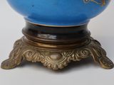 an image of a blue vase on a gold stand