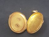 two gold lockes are shown on a black surface