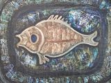 a painting of a fish on a plate on a table