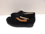 black sued moccali shoes with a leather sole and a rubber sole
