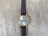 a watch that is sitting on a wooden table