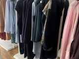 a lot of clothes hanging on a rack in a room