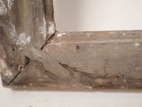 a close up of a broken window frame with peeling paint