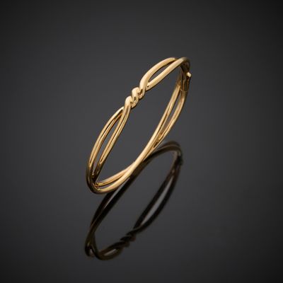 a gold ring with a knot on it