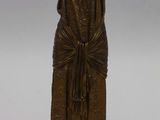 bronze statue of a woman with a shaw around her neck