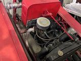 a small engine in a red car in a garage