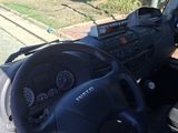 a man that is driving a truck down the street