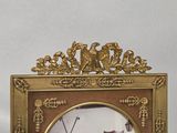 a picture of a gold frame with a clock on it