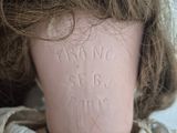 a doll that has a lot of hair on it ' s head