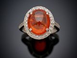 an orange sapphire and diamond ring